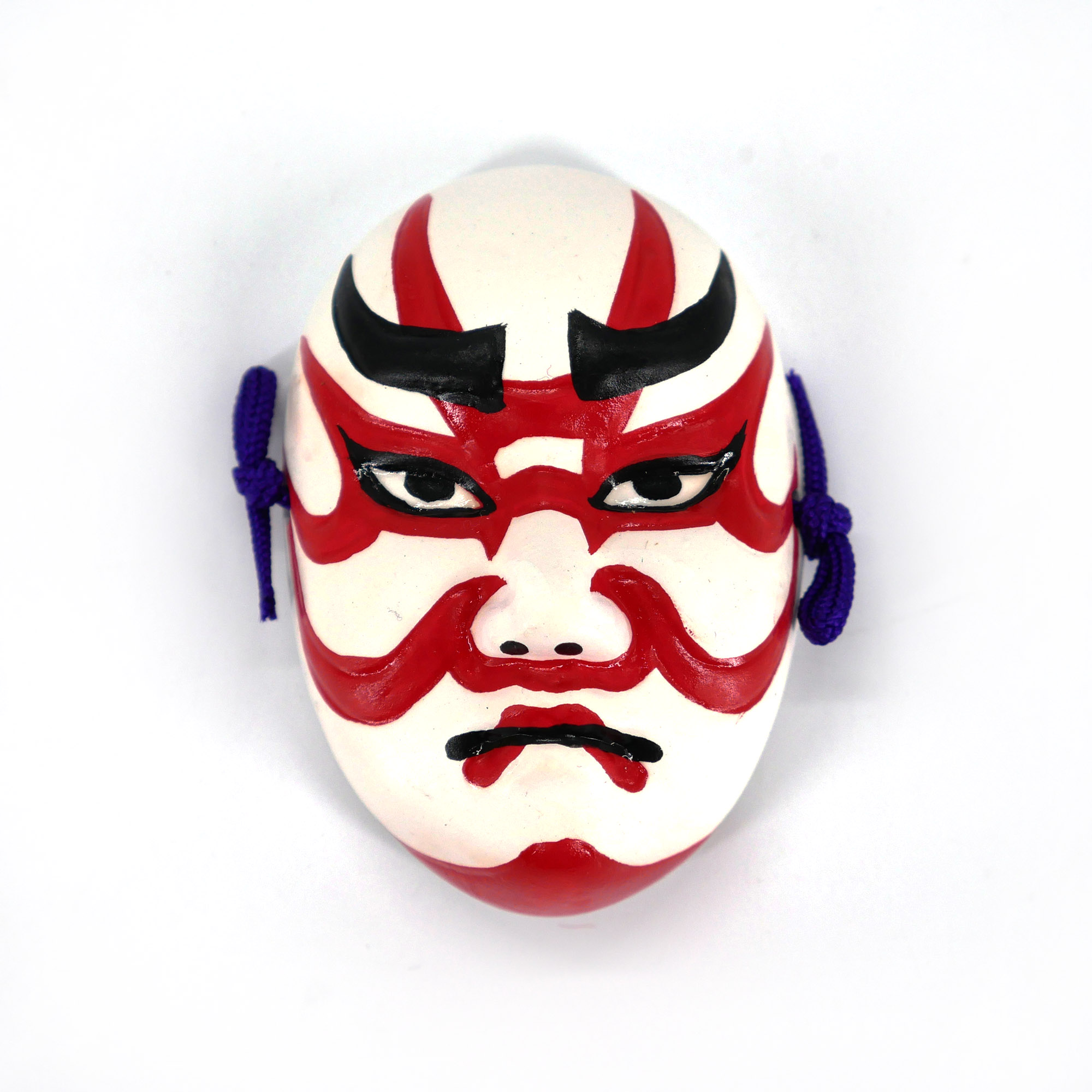 Mini noh mask representing a traditional white and red ceramic